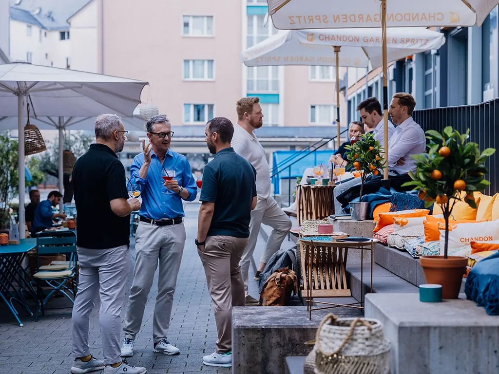 Leute Netzwerken bei einem Aperitiv vor einer Lokalität